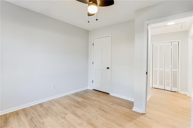 unfurnished bedroom with ceiling fan and light wood-type flooring