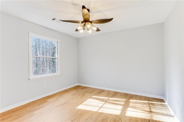 spare room with hardwood / wood-style flooring and ceiling fan