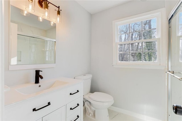 bathroom with vanity, toilet, and walk in shower