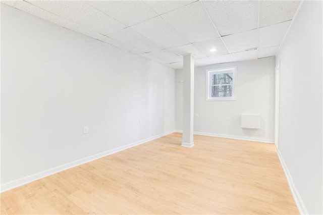 basement featuring hardwood / wood-style flooring and a drop ceiling