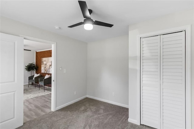 389 Oglesby Bridge Rd SE, Conyers, GA 30094 - unfurnished bedroom with baseboards, carpet, a closet, and ceiling fan