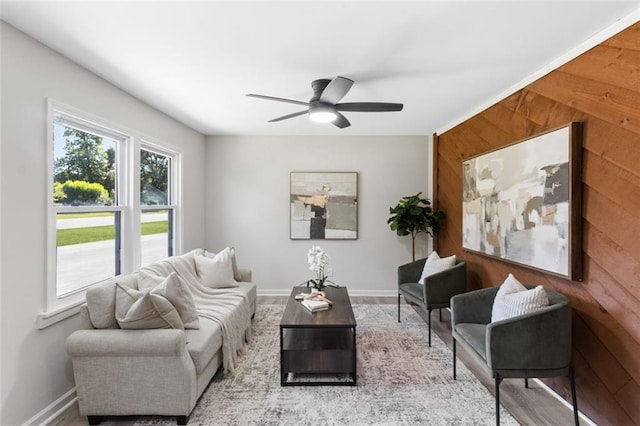 389 Oglesby Bridge Rd SE, Conyers, GA 30094 - living area featuring wood walls, a ceiling fan, baseboards, and wood finished floors