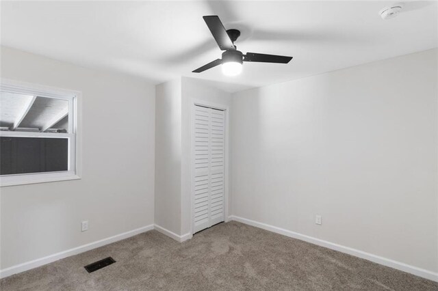 389 Oglesby Bridge Rd SE, Conyers, GA 30094 - unfurnished bedroom featuring carpet floors, a closet, baseboards, and ceiling fan