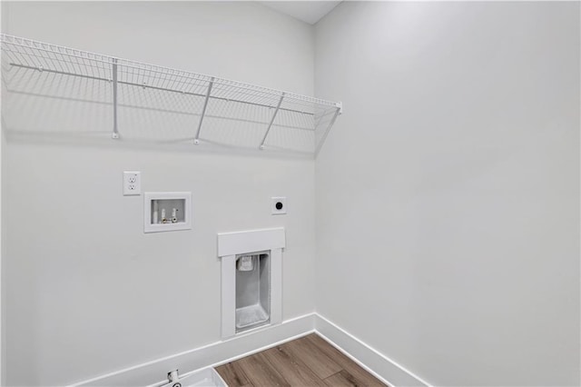 6811 Cambridge Dr, Flowery Branch, GA 30542 - laundry area with electric dryer hookup, hookup for a washing machine, cabinets, light wood-type flooring, and hookup for a gas dryer