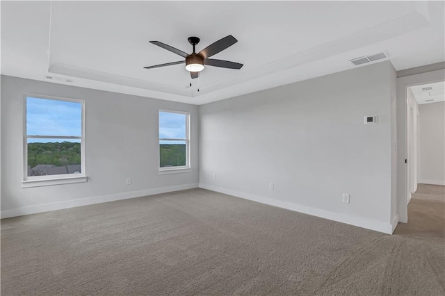 6811 Cambridge Dr, Flowery Branch, GA 30542 - empty room featuring ceiling fan, light colored carpet, and a tray ceiling