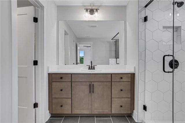 6811 Cambridge Dr, Flowery Branch, GA 30542 - bathroom with a shower with door, vanity, and tile patterned floors