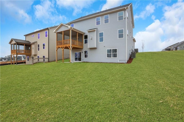 rear view of property featuring central AC unit and a yard