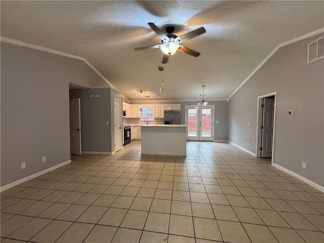 kitchen featuring vaulted ceiling, crown molding, black appliances, light tile patterned floors, and white cabinets