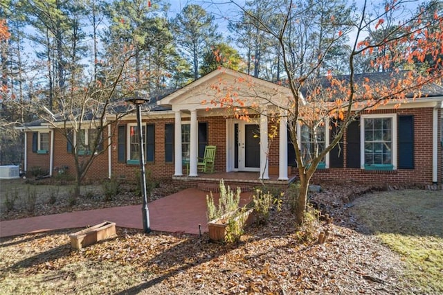 200 Mcguirts Bridge Rd, Covington, GA 30014 - view of front of home featuring a porch, brick siding, and central AC