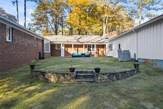 200 Mcguirts Bridge Rd, Covington, GA 30014 - rear view of house with board and batten siding, a yard, and brick siding
