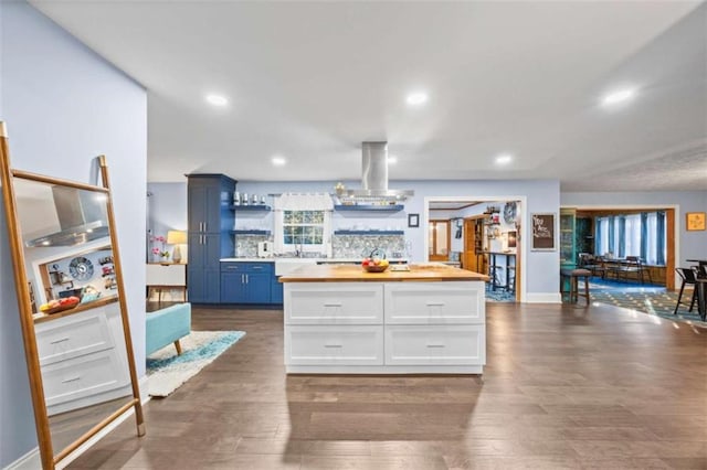 200 Mcguirts Bridge Rd, Covington, GA 30014 - kitchen with wooden counters, island range hood, open shelves, white cabinetry, and recessed lighting