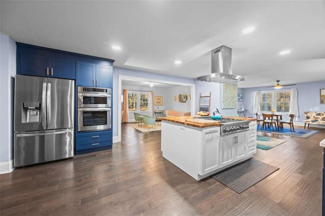 200 Mcguirts Bridge Rd, Covington, GA 30014 - kitchen featuring stainless steel appliances, island range hood, wood counters, dark wood-type flooring, and white cabinets