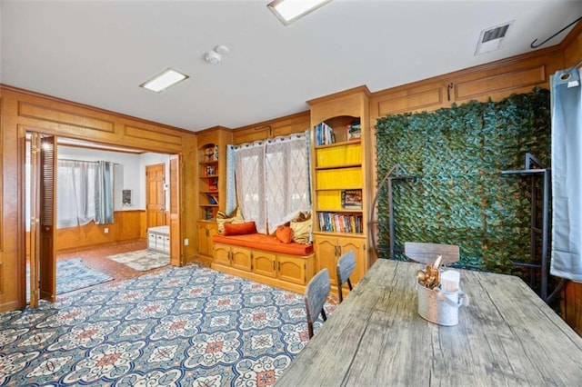 200 Mcguirts Bridge Rd, Covington, GA 30014 - dining space featuring wooden walls, built in features, and carpet floors