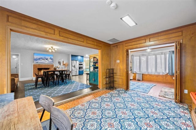 200 Mcguirts Bridge Rd, Covington, GA 30014 - living area featuring a brick fireplace, baseboards, and wood walls
