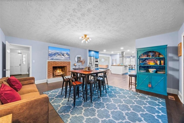200 Mcguirts Bridge Rd, Covington, GA 30014 - dining space with baseboards, a fireplace, wood finished floors, and a textured ceiling