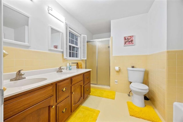 200 Mcguirts Bridge Rd, Covington, GA 30014 - bathroom featuring tile walls, a shower stall, toilet, double vanity, and wainscoting