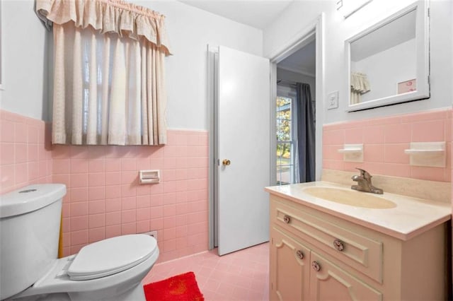 200 Mcguirts Bridge Rd, Covington, GA 30014 - bathroom featuring tile walls, toilet, vanity, a wainscoted wall, and tile patterned flooring