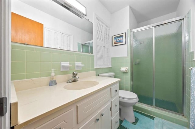 200 Mcguirts Bridge Rd, Covington, GA 30014 - full bath featuring vanity, toilet, a stall shower, tile patterned floors, and tile walls