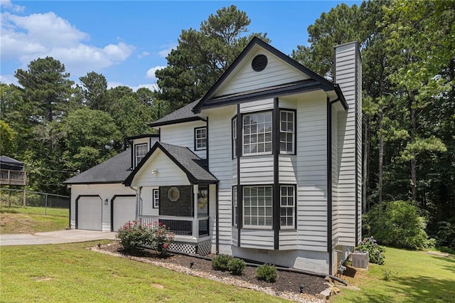 6492 Swift Creek Rd, Lithonia, GA 30058 - traditional-style house featuring a chimney, an attached garage, concrete driveway, roof with shingles, and view of wooded area