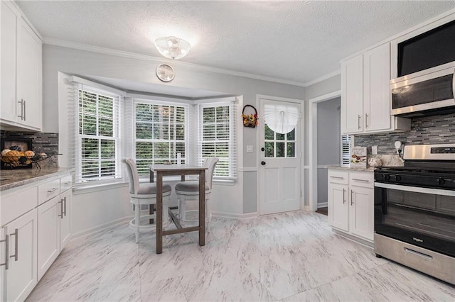 6492 Swift Creek Rd, Lithonia, GA 30058 - kitchen with appliances with stainless steel finishes, tasteful backsplash, white cabinetry, crown molding, and light stone countertops