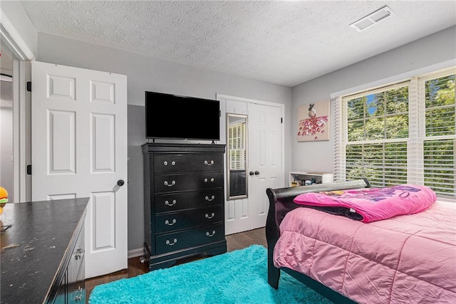 6492 Swift Creek Rd, Lithonia, GA 30058 - bedroom featuring wood finished floors and a textured ceiling