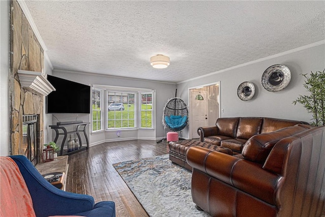 6492 Swift Creek Rd, Lithonia, GA 30058 - living room with wood-type flooring, a glass covered fireplace, a textured ceiling, and crown molding