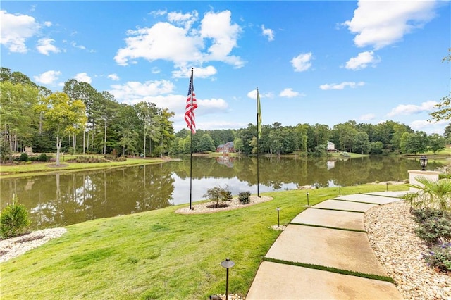 view of home's community with a lawn and a water view