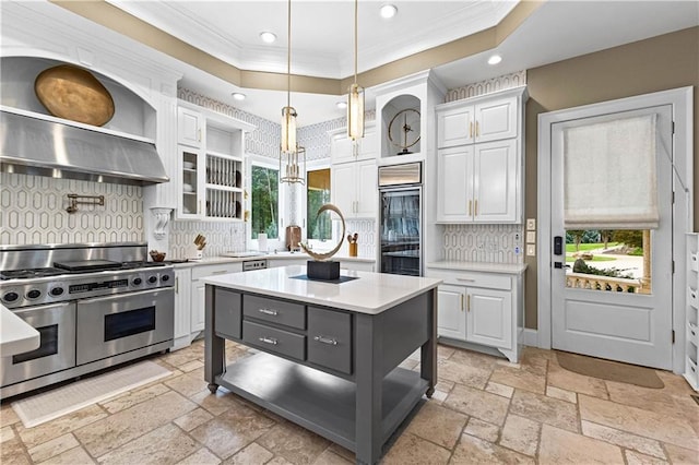 kitchen featuring decorative backsplash, a center island, double oven range, and white cabinets