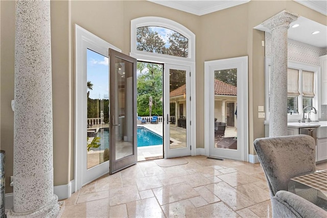 doorway featuring ornate columns, french doors, and crown molding