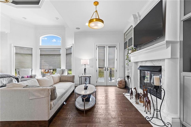 living room with ornamental molding, a fireplace, and dark wood-type flooring