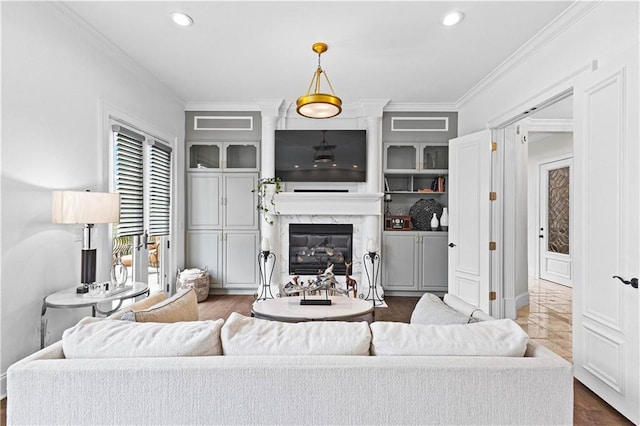 living room featuring ornamental molding, a premium fireplace, and dark hardwood / wood-style flooring