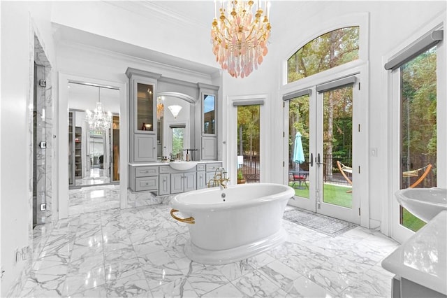 bathroom featuring plenty of natural light, a bath, and vanity