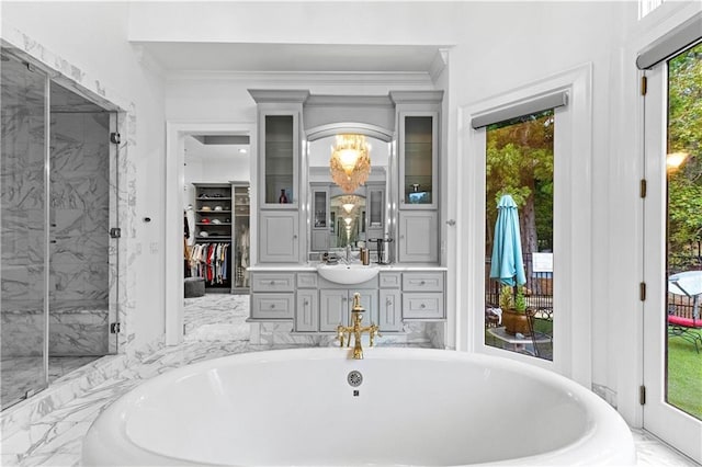 bathroom with crown molding, vanity, and independent shower and bath