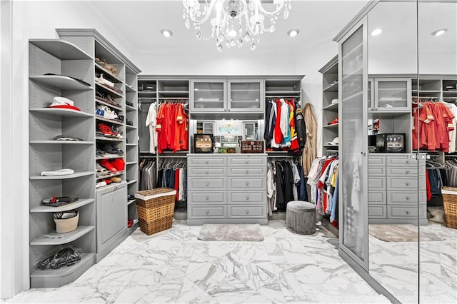 walk in closet with a notable chandelier