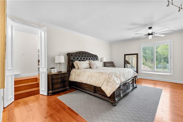 bedroom featuring crown molding, hardwood / wood-style floors, and ceiling fan