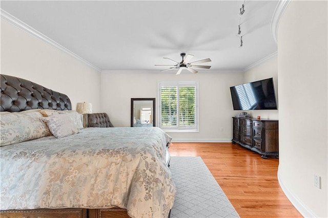 bedroom with ornamental molding, ceiling fan, and hardwood / wood-style floors