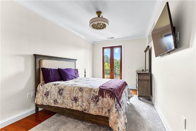 bedroom featuring ceiling fan, french doors, wood-type flooring, ornamental molding, and access to exterior