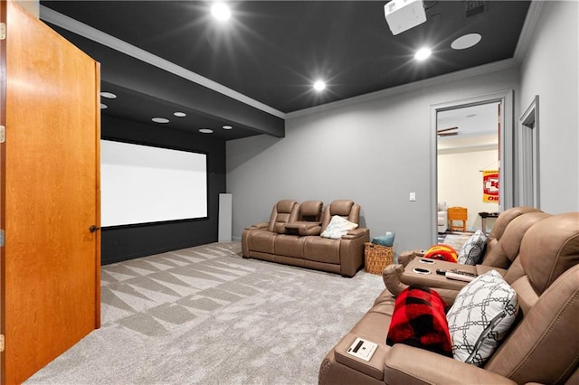 carpeted cinema room featuring crown molding