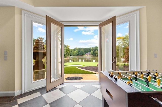 doorway featuring a water view and a healthy amount of sunlight