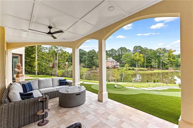 view of patio with an outdoor living space, a water view, and ceiling fan