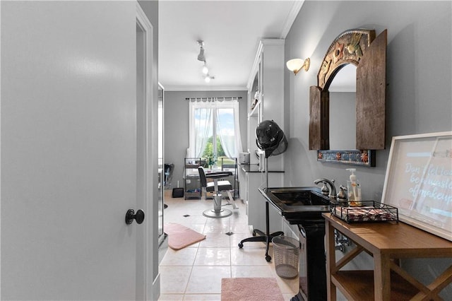 tiled home office featuring crown molding and sink