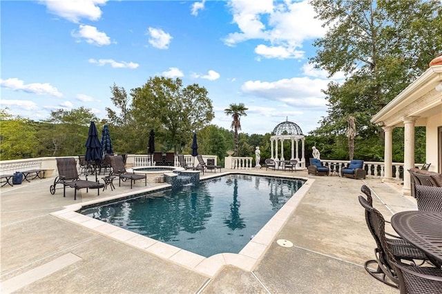 view of pool with an in ground hot tub, a gazebo, and a patio