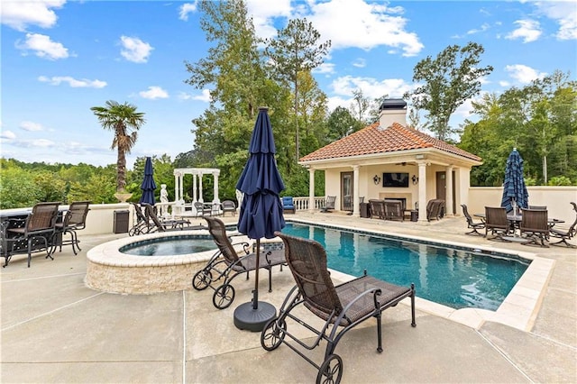 view of swimming pool featuring a gazebo, an in ground hot tub, and a patio area