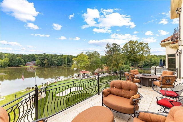 balcony featuring a water view and a patio area