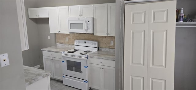 6354 Shannon Pkwy Unit 20D, Union City, GA 30291 - kitchen featuring white appliances, light stone countertops, white cabinets, and tasteful backsplash