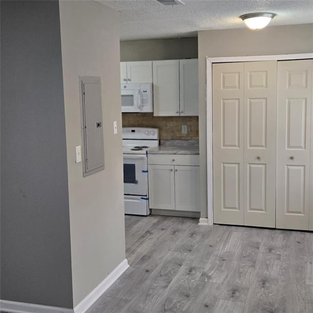 6354 Shannon Pkwy Unit 20D, Union City, GA 30291 - kitchen featuring electric panel, a textured ceiling, white appliances, and white cabinets