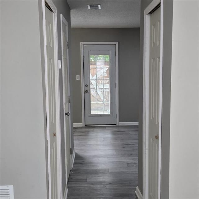 6354 Shannon Pkwy Unit 20D, Union City, GA 30291 - hallway featuring baseboards, dark wood finished floors, visible vents, and a textured ceiling
