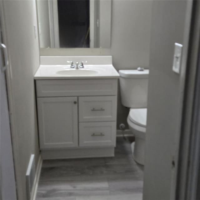 6354 Shannon Pkwy Unit 20D, Union City, GA 30291 - bathroom with toilet, baseboards, vanity, and wood finished floors