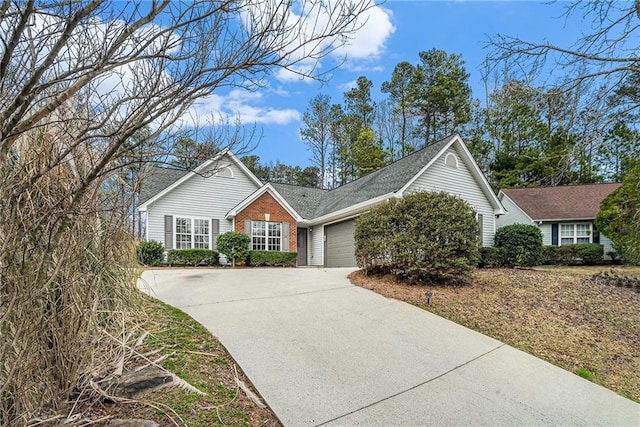 view of front of property with a garage, concrete driveway, and brick siding