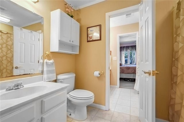 bathroom featuring vanity, toilet, and tile patterned flooring